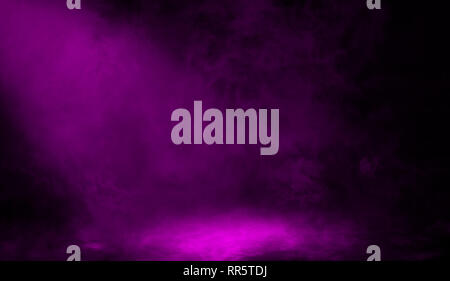 Abstract purple spotlight with smoke mist fog on black background. Stock Photo