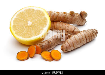 Fresh turmeric with slices and lemon isolated on white background Stock Photo