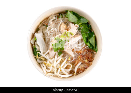 Asian rice noodles soup with vegetables and chicken in bowl. Top view flat lay isolated on white background. Stock Photo