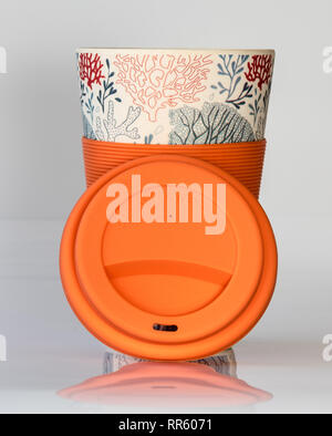 Reusable coffee cup made from natural material with silicone sleeve and lid for a sustainable environment Stock Photo