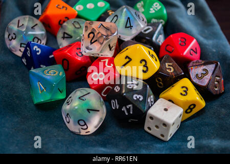 various polyhedral game dice strewn about on a table Stock Photo