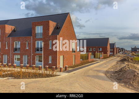 Newly built houses in modern street building site in suburb of city in the Netherlands Stock Photo