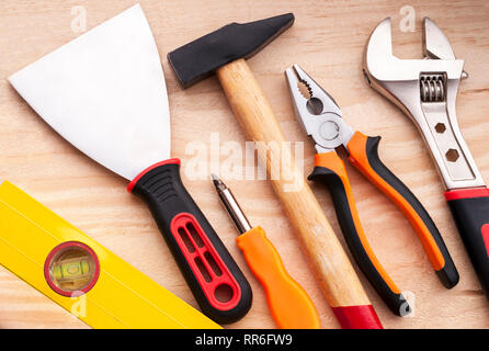 Level, spatula, screwdriver, hammer, pliers, adjustable wrench. Set of construction tools on a concrete background Stock Photo