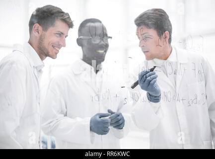 promising scientist makes notes on the Board Stock Photo