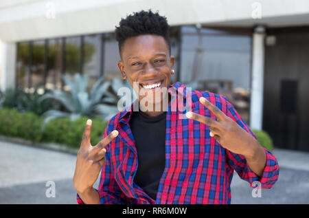 Funny dancing african american young adult guy outdoor in the city Stock Photo