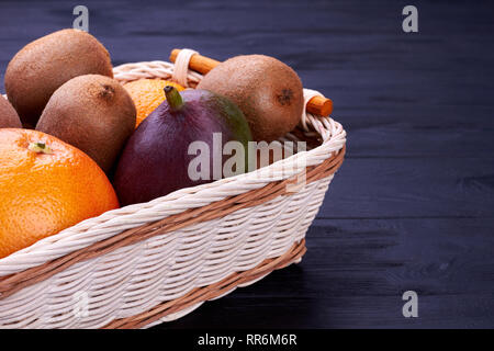 Fresh tropical fruits in basket. Stock Photo