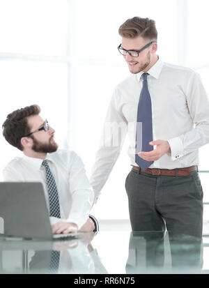 two employees discuss business issues near the office Desk Stock Photo