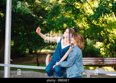 Image of young amazing women friends students take selfie Stock Photo