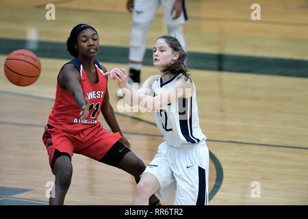 Player dishing off a pass to a teammate while being closely defended. USA. Stock Photo