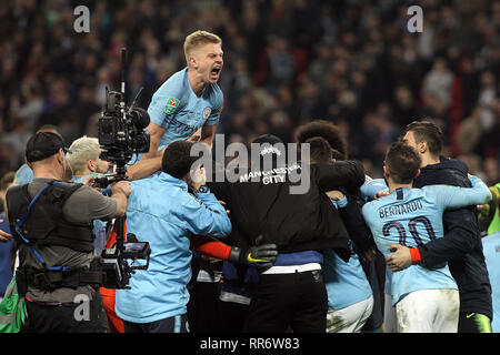 Oleksandr Zinchenko of Manchester City (top ) shows his delight as Ederson , the goalkeeper of Manchester City (hidden) is mobbed by his team mates after his team win the penalty shoot out. Carabao Cup final match, Chelsea v Manchester city at Wembley Stadium in London on Sunday 24th February 2019.  this image may only be used for Editorial purposes. Editorial use only, license required for commercial use. No use in betting, games or a single club/league/player publications . pic by Steffan Bowen/Andrew Orchard sports photography/Alamy Live news Stock Photo