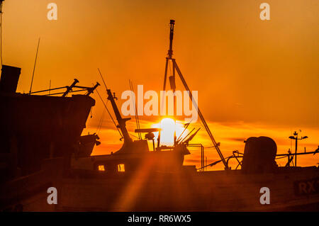 Hastings, East Sussex, UK.24 Febuary 2019..Sunset over the old town fishing fleet after a glorious Spring like day on the South coast.. . Stock Photo