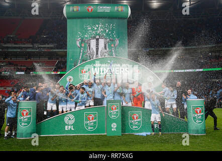 London, UK. 24th Feb, 2019. Manchester City's players celebrate with the trophy after the Carabao Cup Final match between Chelsea and Manchester City at Wembley Stadium in London, Britain on Feb. 24, 2019. Manchester City won 4-3 on penalties after a 0-0 draw. Credit: Matthew Impey/Xinhua/Alamy Live News Stock Photo