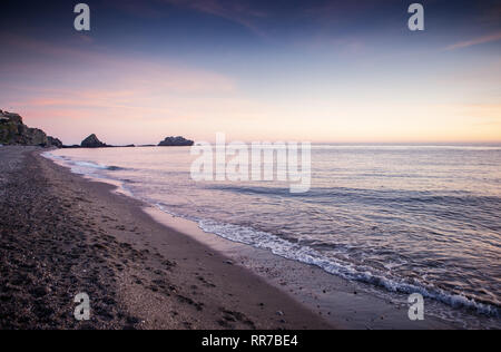 sunset in the costa tropical almunecar spain with the large cross of Penones del Santo in the background Stock Photo