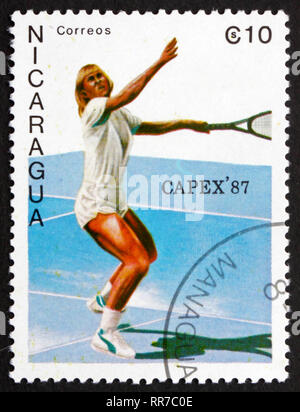 NICARAGUA - CIRCA 1987: a stamp printed in Nicaragua shows Female Tennis Player in Action, circa 1987 Stock Photo