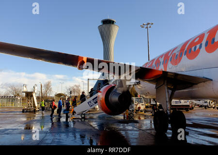 Passengers boarding an easyjet plane at Edinburgh airport viewed from under the wing as the climb steps up Scotland UK Stock Photo