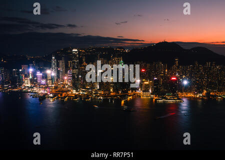 Sunset over Hong Kong Island seen from Kowloon skyscraper Stock Photo