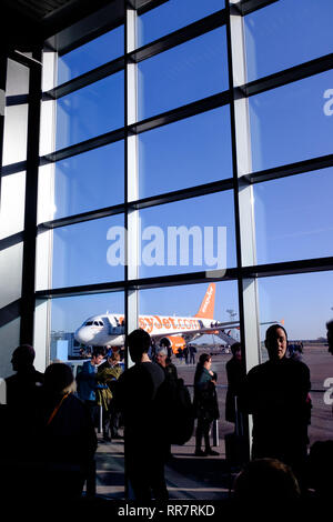 Passengers waiting to board a flight at gate from Copenhagen airport terminal Denmark Scandinavia Stock Photo