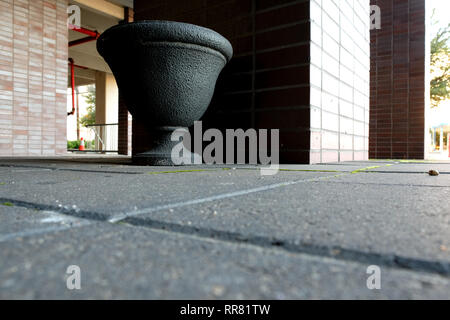 Decorative urn ashtray placed outside of an office building for smokers; exterior designated smoking area; Bryan, Texas, USA. Stock Photo