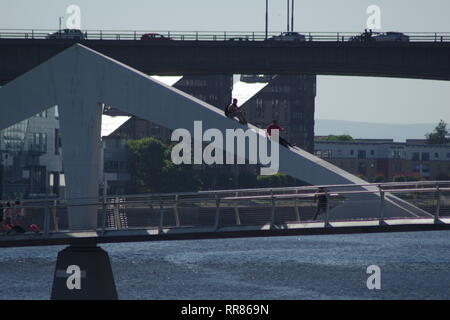 People Climbing the Tradeston Bridge, Pedestrian Bridge over the River Clyde, Glasgow, Scotland, UK. Summer.