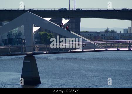 People Climbing the Tradeston Bridge, Pedestrian Bridge over the River Clyde, Glasgow, Scotland, UK. Summer.