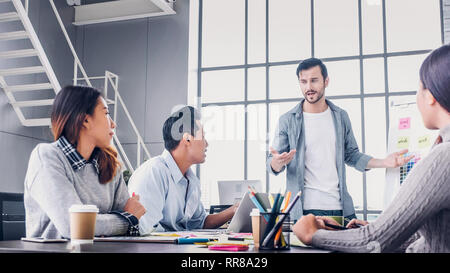 Creative director team lead brainstrom branding project with designer team at meeting table.discussion idea in creative office Stock Photo