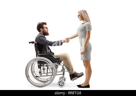 Full length shot of a bearded man in a wheelchair shaking hands with a young woman isolated on white background Stock Photo