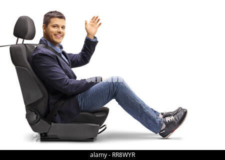Full length shot of a young man in a car seat with a fastened seatbelt holding a steering wheel isolated on white background Stock Photo