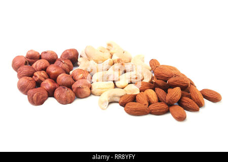 Mixed nuts from hazelnuts, almonds, cashews isolated on white background. Selective focus. Stock Photo