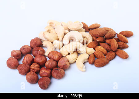 Mixed nuts from hazelnuts, almonds, cashews isolated on white background. Selective focus. Stock Photo