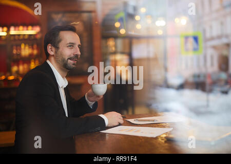 Pensive Businessman in Cafe Stock Photo