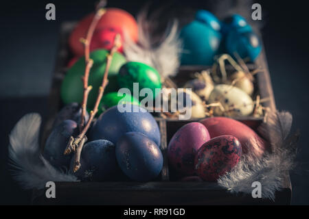 Various Easter eggs in small wooden box Stock Photo
