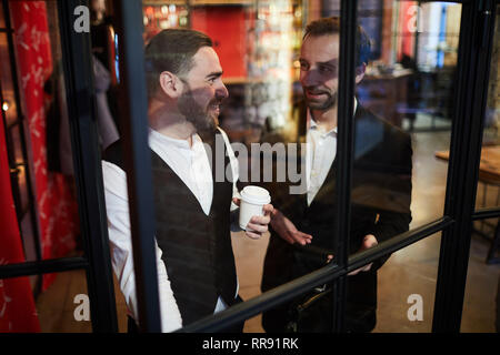 Two Gentlemen by Window in Restaurant Stock Photo