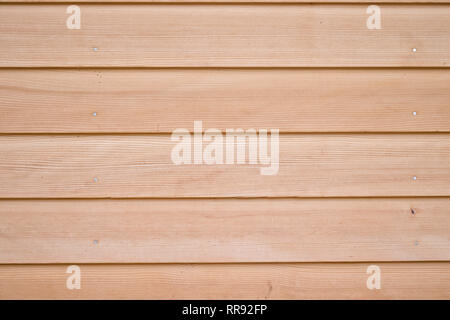 Texture of beige and brown wood planks held together by nails. Stock Photo