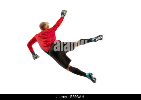 Male soccer player goalkeeper catching ball in jump. Silhouette of fit man with ball isolated on white studio background Stock Photo