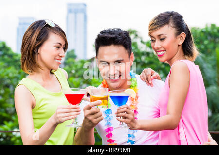 Smiling friends holding cocktail Stock Photo