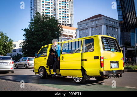 Johannesburg, South Africa, 28 November - 2018: Passenger getting out of mini bus taxi. Stock Photo