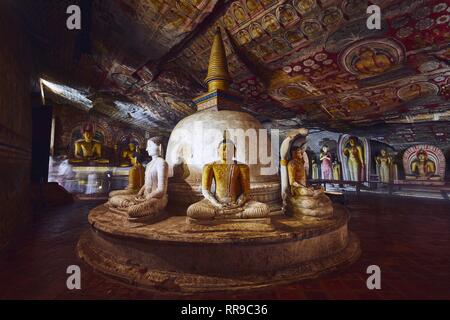 Dambulla, Sri Lanka - January 12, 2019: Statues and paintings inside  of largest and best preserved cave temple complex in Sri Lanka. Golden Temple of Stock Photo