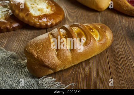 Festive Russian Kurnik sliced pie stuffed with chicken, potatoes and onions  close up on a slate board on the table. vertical top view above Stock Photo  - Alamy