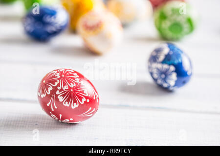 Close-up multicolored easter eggs on wooden table. Stock Photo