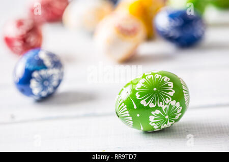 Close-up multicolored easter eggs on wooden table. Stock Photo