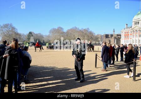 a policeman with a machine gun guards the changing of the guard at horse guards parade london UK Stock Photo