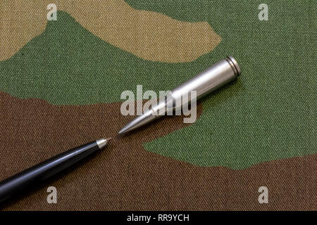 Silver rifle bullets against pen - a press freedom concept Stock Photo