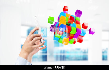 Integrating new technologies concept with cube figure floating in air. Mixed media Stock Photo
