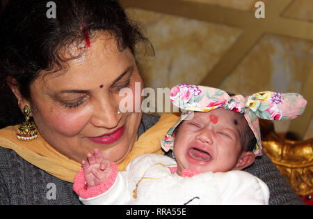 Newborn baby girl crying Stock Photo