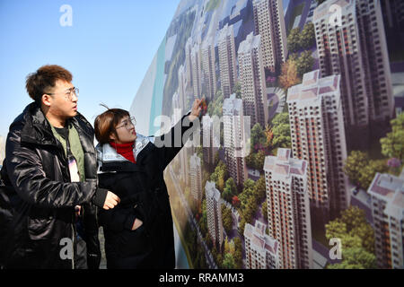 (190225) -- TIANJIN, Feb. 25, 2019 (Xinhua) -- Zhang Shiyu (R) and Lyu Xin check the position of their wedding house in north China's Tianjin, Feb. 1, 2019. Zhang Shiyu and Lyu Xin got married in 2018. Although the couple work in Beijing, they chose to buy their wedding house in the neighboring Tianjin City,where Zhang Shiyu was born, given the convenience brought by the Beijing-Tianjin-Hebei integration. They now go to Tianjin every two weeks and return to Beijing on Sunday nights. Thanks to the development of Beijing, Tianjin and Hebei Province -- a regional city cluster called 'Jing-jin-ji' Stock Photo