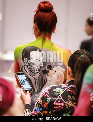 Excel, London, UK. 25th Feb, 2019. Make-up artist 'Mishel' applies makeup to a model in the Walt Disney category of the Warpaint competition. The design features a picture of Walt Disney painted from a photograph. The Professional Beauty London show brings together hair and beauty practitioners, cosmetics and aesthetics professionals, and representatives from over 800 brands with those interested in hair and beauty in the UK's biggest industry event at ExCel London Exhibition Centre. Credit: Imageplotter/Alamy Live News Stock Photo