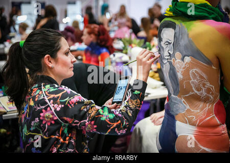 Excel, London, UK. 25th Feb, 2019. Make-up artist 'Mishel' applies makeup to a model in the Walt Disney category of the Warpaint competition. The design features a picture of Walt Disney painted from a photograph. The Professional Beauty London show brings together hair and beauty practitioners, cosmetics and aesthetics professionals, and representatives from over 800 brands with those interested in hair and beauty in the UK's biggest industry event at ExCel London Exhibition Centre. Credit: Imageplotter/Alamy Live News Stock Photo