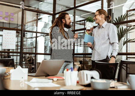 Positive joyful man using a skull model Stock Photo
