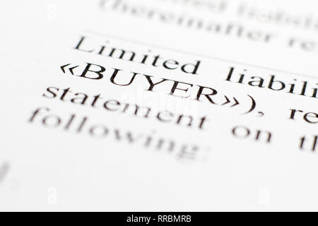 Fragment of a contract printed on paper. Macrophoto Word Buyer Closeup. The buyer and the seller made a contract on paper. Selective focus. Stock Photo