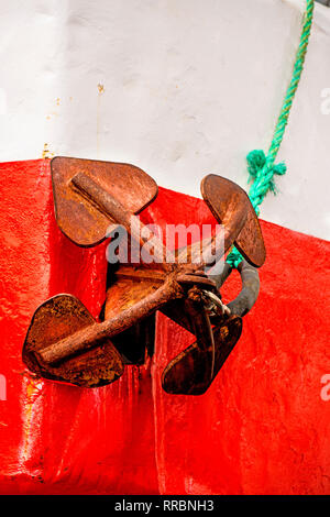 rusty anchor on red and white ship Stock Photo